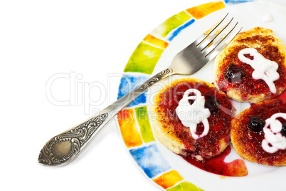 Cottage cheese pancakes on a colorful plate with fork Cottage cheese pancakes on a colorful plate with fork