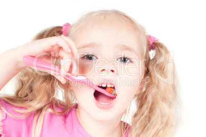 Little cute girl in studio brushing teeth