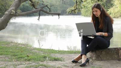 The girl with the laptop on the nature