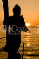 woman silhouette on yacht nose