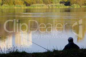 fisherman silhouette near pond