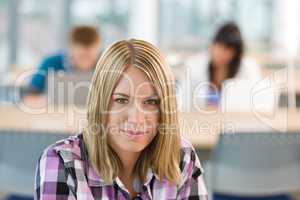 Thoughtful female student in classroom