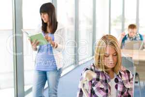 Student reading book in classroom