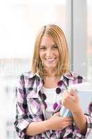 Happy young woman holding books