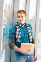 Male teenager holding book