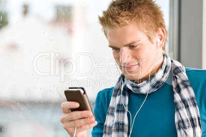 Male teenager with mp3 player and earbuds