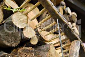 stacked wood logs and rake