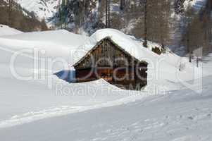 alpine wooden house in the snow