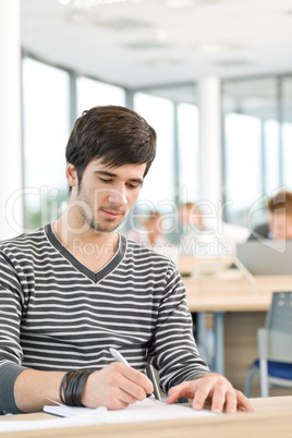 High school - Young male student write notes