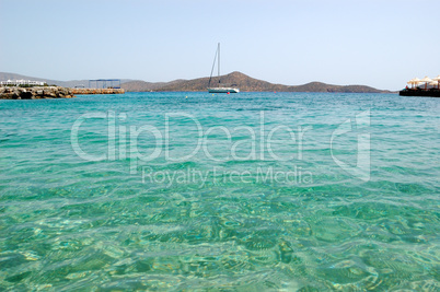 Turquoise Aegean Sea near beach of luxury hotel with yacht view,