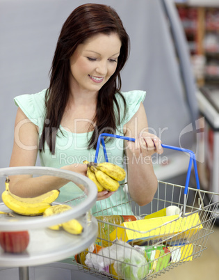 woman buying bananas in a grocery shop