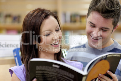 couple reading a book in the science department