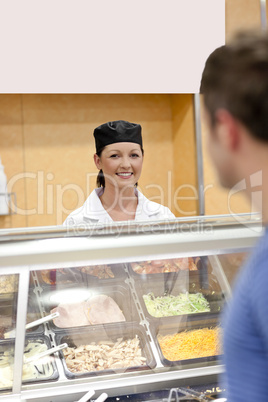 cook standing behind the refrigerated display
