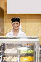 cute baker smiling at a customer in a  cafeteria