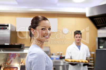 woman buying baguette from a baker