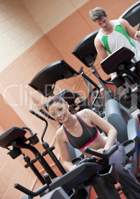 people doing exercises using equipments