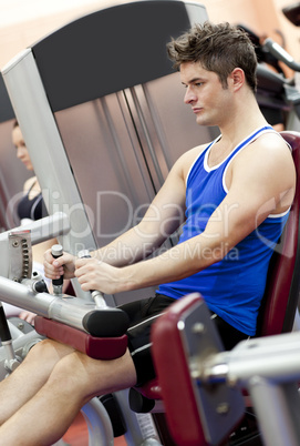 man using a leg press  in the weights