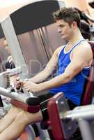 man using a leg press  in the weights