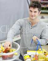 man with shopping-basket buying fruits