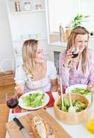 women having fun while eating salad