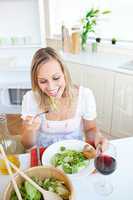 woman eating a salad in the kitchen