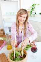 woman serving salad sitting in the kitchen