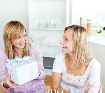 woman receiving a present during a birthday party