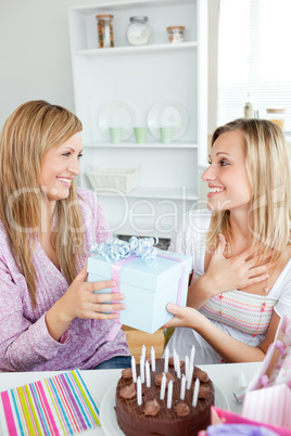 woman receiving a gift during her birthday party