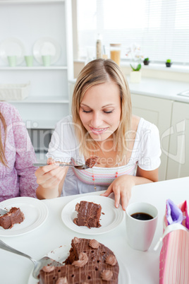 woman eating a piece of chocolate cake