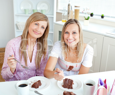 women eating a chocolate cake