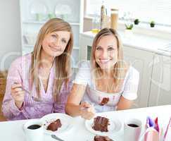 women eating a chocolate cake