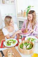 Young woman eating salad