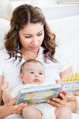 mother reading a book to her baby