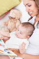 mother reading a book to her baby