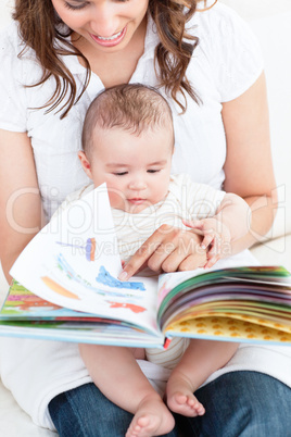 mother showing a book to her baby