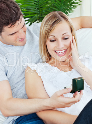 Happy woman receiving a wedding ring