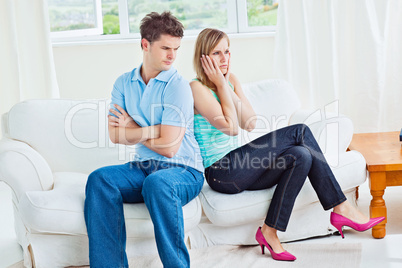 Angry couple sitting on the sofa