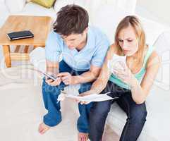 couple calculating bills at home
