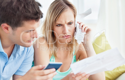 couple calculating bills using a calculator