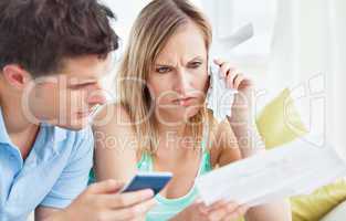 couple calculating bills using a calculator