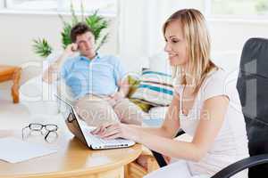 woman working on her laptop with boyfriend