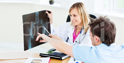 female doctor showing an x-ray to a patient