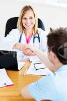 female doctor shaking hands with patient