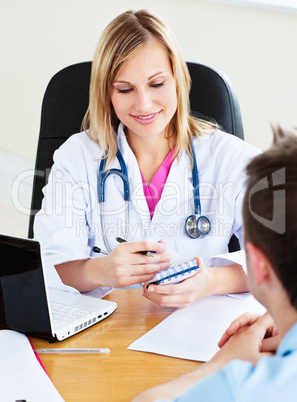 doctor writing a prescription to her patient