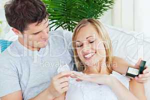 man giving a wedding ring to his girlfriend
