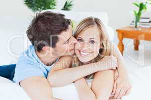 boyfriend kissing his smiling girlfriend