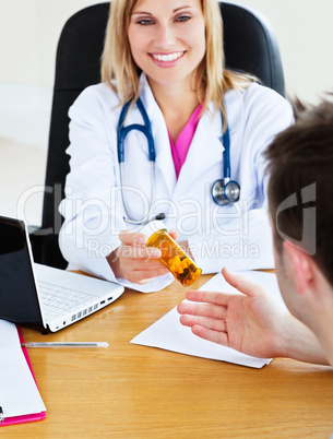 doctor giving pills to her patient