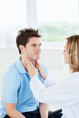 doctor examinating the throat of a patient