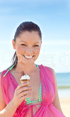 happy woman in bikini eating an ice-cream