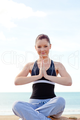 woman medidating  sitting on the beach